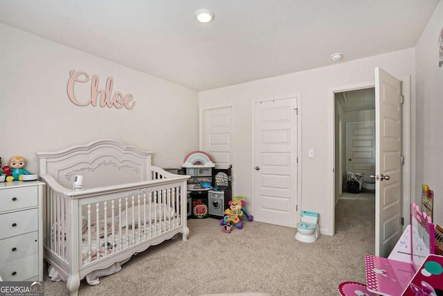 bedroom featuring carpet flooring and a crib