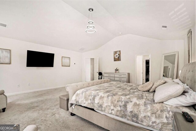 carpeted bedroom with vaulted ceiling