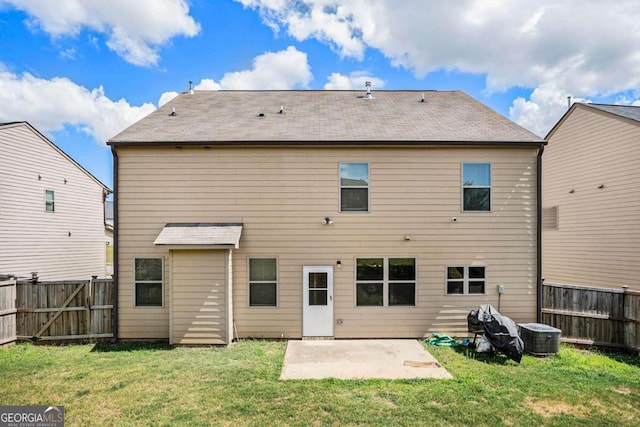 rear view of property with a lawn and a patio area