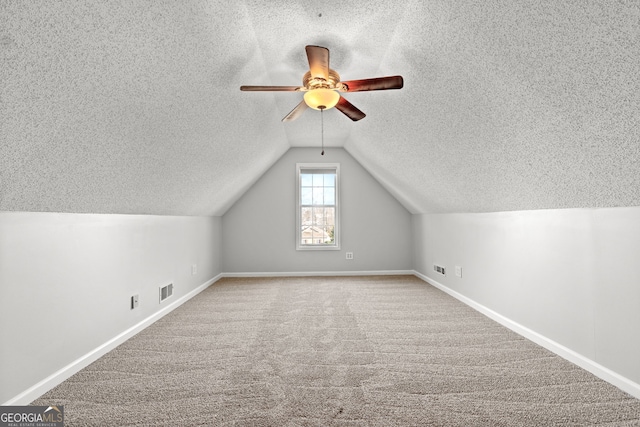 bonus room with carpet, ceiling fan, and vaulted ceiling