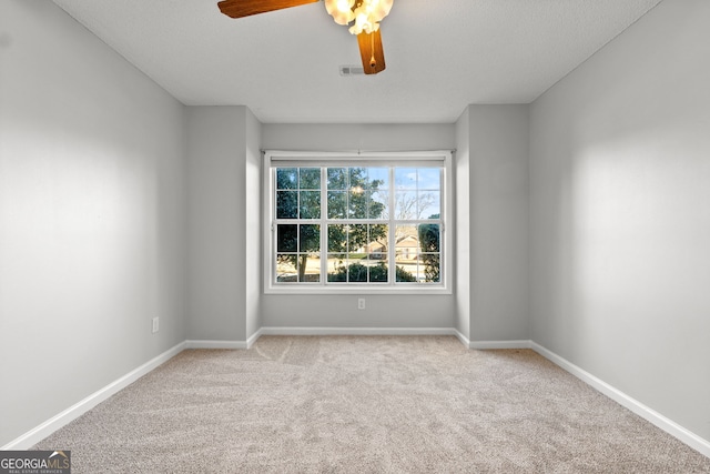 carpeted empty room featuring ceiling fan