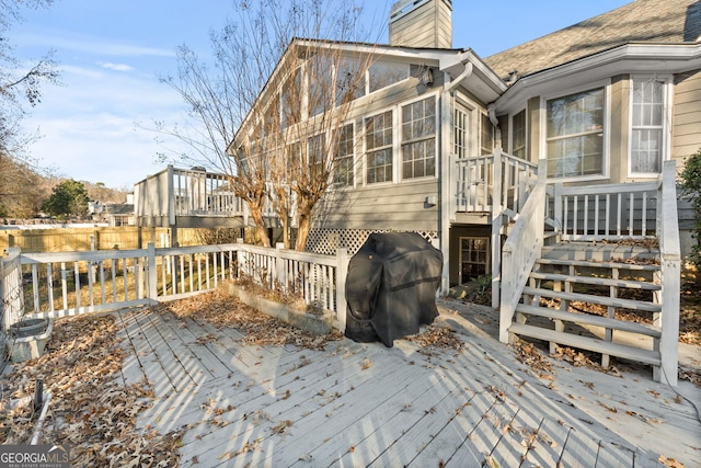 wooden terrace with a sunroom and grilling area