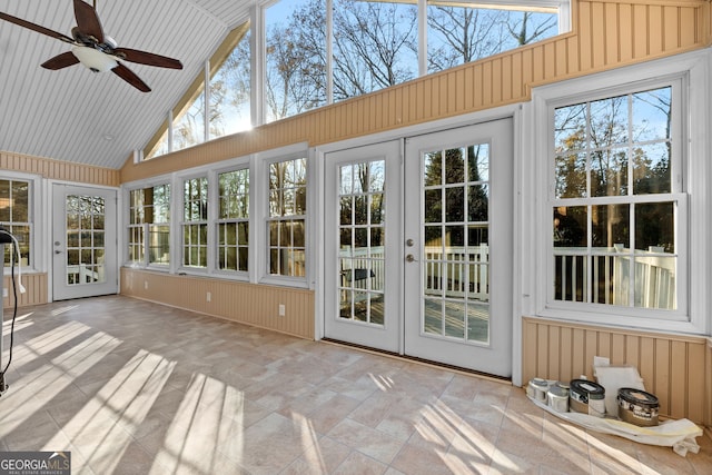 unfurnished sunroom featuring a wealth of natural light, french doors, ceiling fan, and lofted ceiling