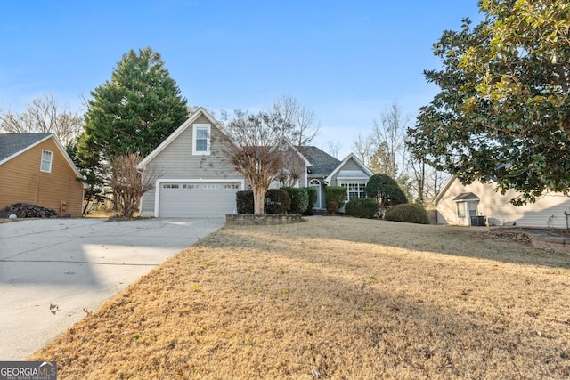 view of property with a front yard and a garage