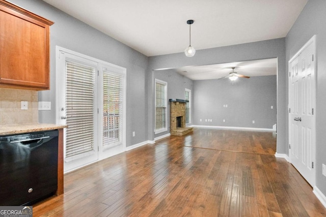 unfurnished living room featuring ceiling fan and dark hardwood / wood-style flooring