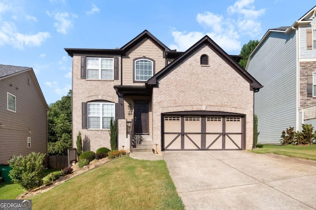 view of front of house featuring a garage, driveway, brick siding, and a front yard