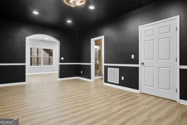 living room with built in features and light hardwood / wood-style flooring