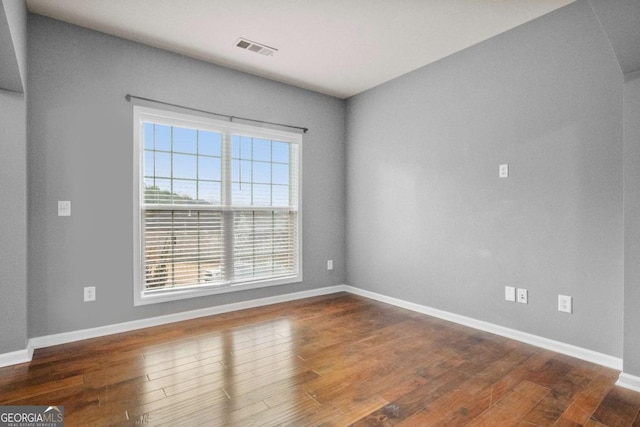 spare room featuring dark hardwood / wood-style flooring