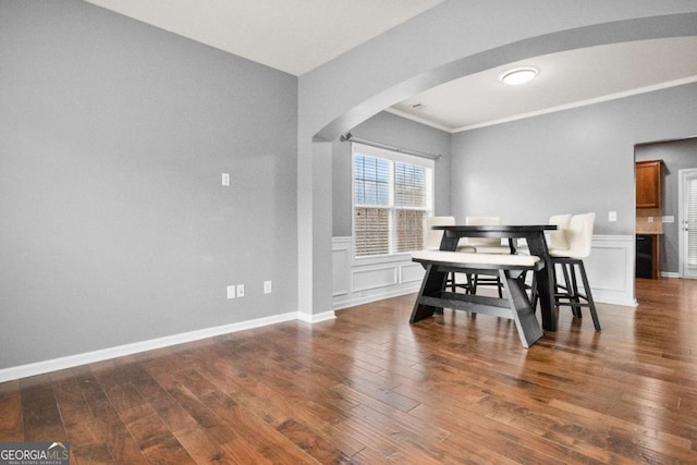 dining area featuring crown molding and dark wood-type flooring