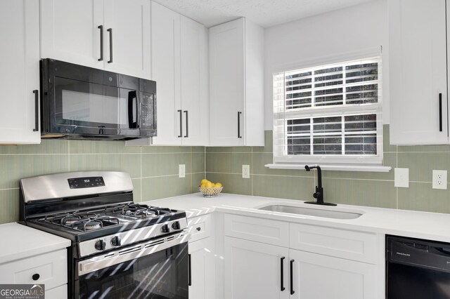 kitchen with white cabinets, decorative backsplash, sink, and black appliances