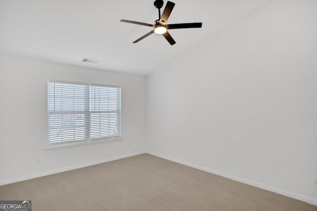 unfurnished room with light colored carpet and ceiling fan