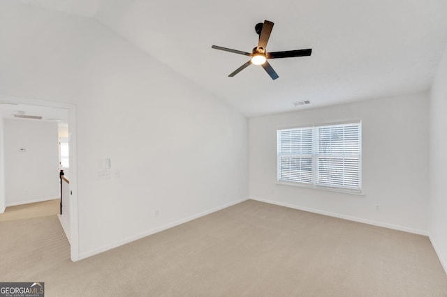 carpeted spare room with ceiling fan and lofted ceiling