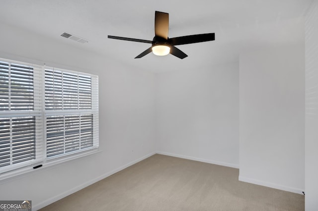 carpeted empty room featuring ceiling fan