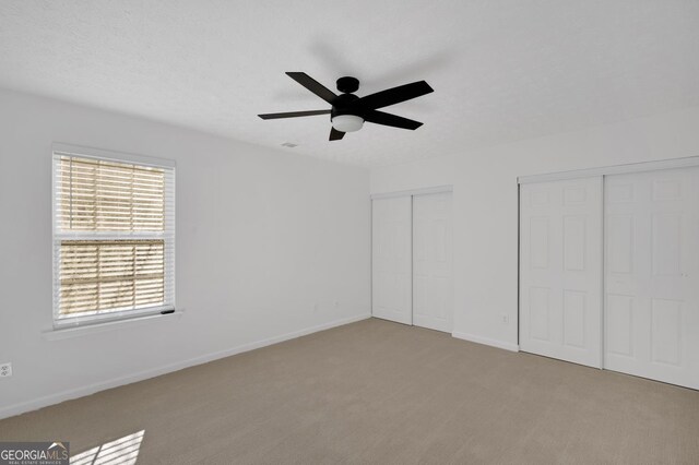 empty room featuring carpet floors and ceiling fan