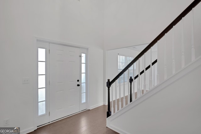 foyer with a healthy amount of sunlight and dark hardwood / wood-style flooring