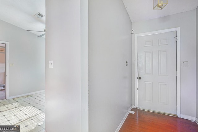 hallway with lofted ceiling