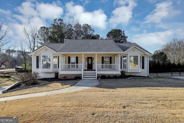 ranch-style home featuring a porch and a front yard