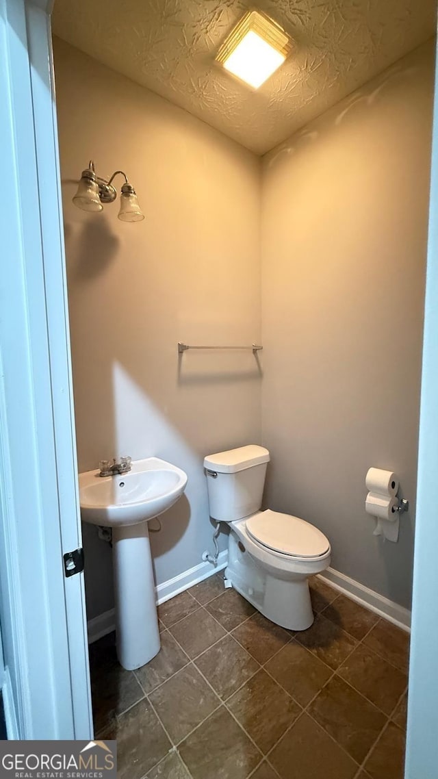 bathroom featuring toilet and sink