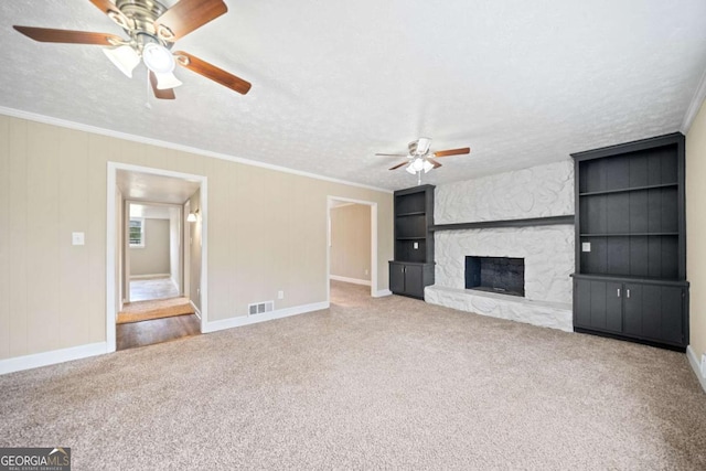 unfurnished living room with a fireplace, ornamental molding, and a textured ceiling