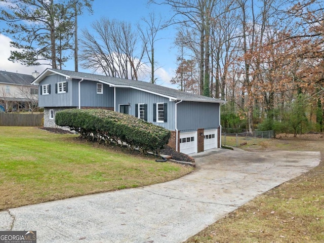 view of side of property with a yard and a garage