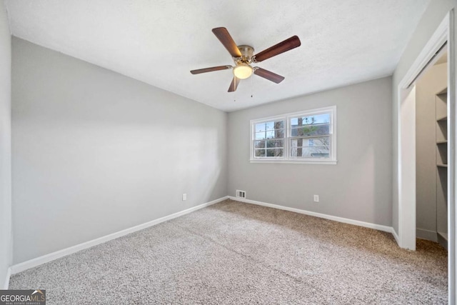 interior space featuring carpet, a closet, and ceiling fan