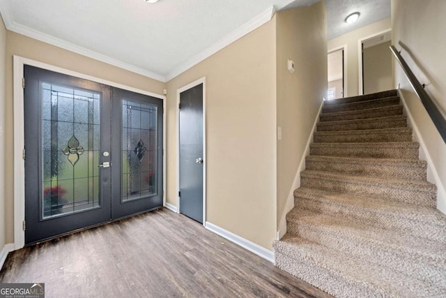 foyer with crown molding and wood-type flooring