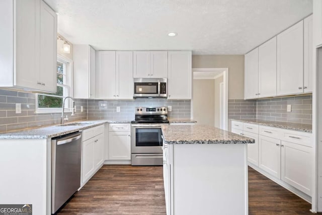 kitchen with sink, white cabinetry, and stainless steel appliances