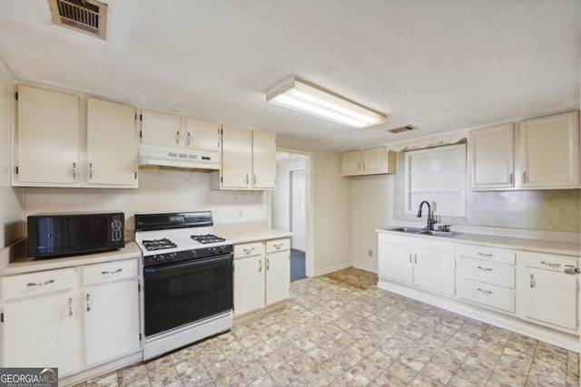 kitchen featuring white gas stove and sink