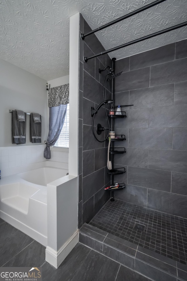 bathroom with plus walk in shower and a textured ceiling