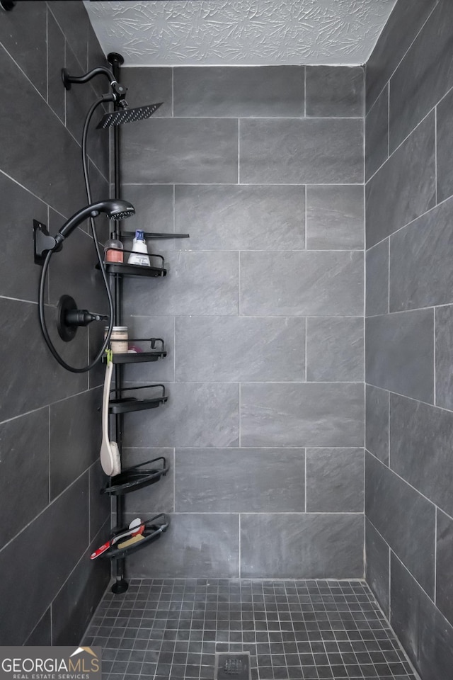 bathroom with tiled shower