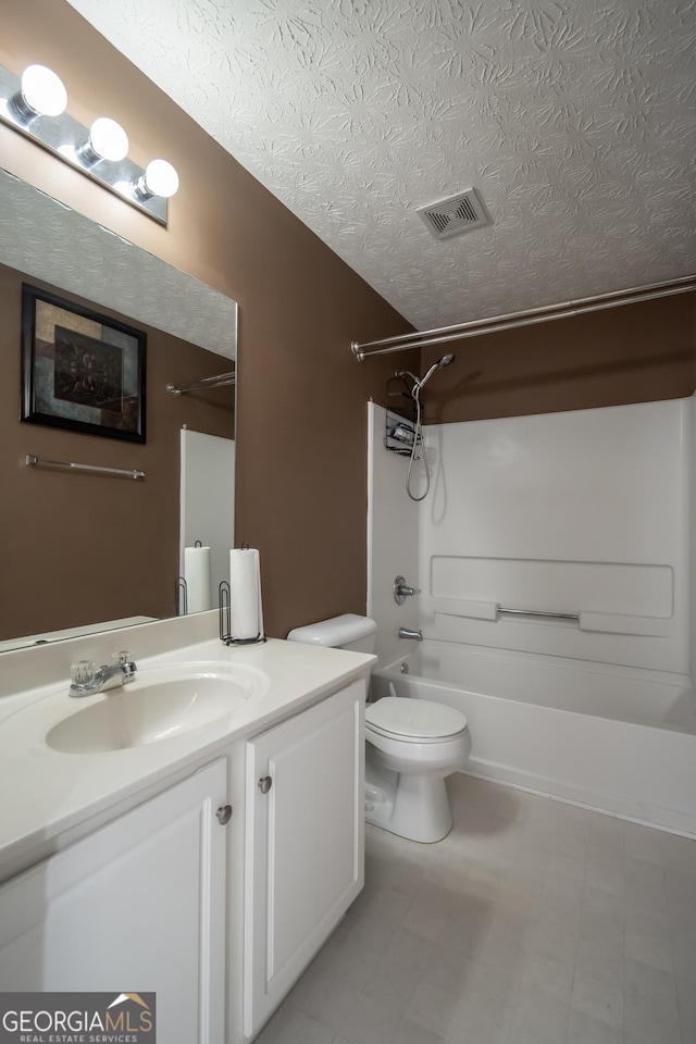 full bathroom featuring bathtub / shower combination, a textured ceiling, vanity, and toilet