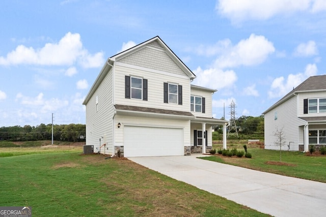 view of front of home featuring central AC unit, a garage, and a front yard