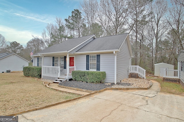 view of front of property with a shed and a front yard