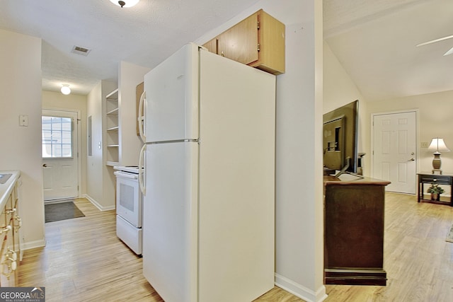 kitchen featuring light brown cabinetry, white appliances, light hardwood / wood-style flooring, and ceiling fan