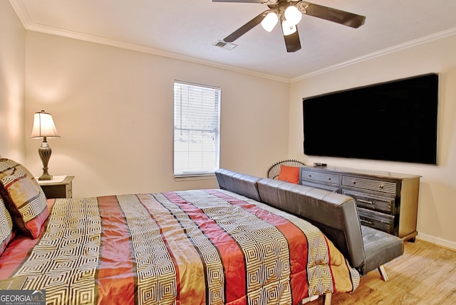 bedroom with ceiling fan, ornamental molding, and light hardwood / wood-style flooring