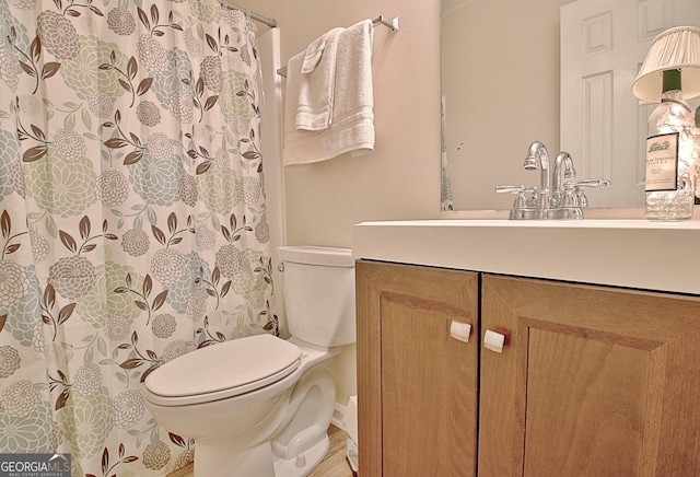 bathroom featuring vanity and toilet