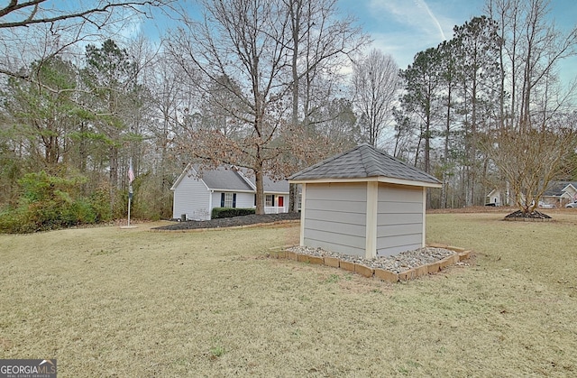 view of outdoor structure featuring a lawn