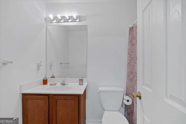 bathroom featuring vanity and toilet