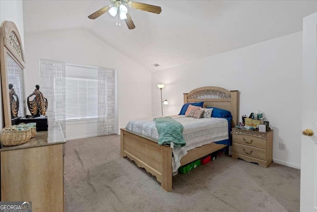 bedroom featuring ceiling fan, light colored carpet, and vaulted ceiling