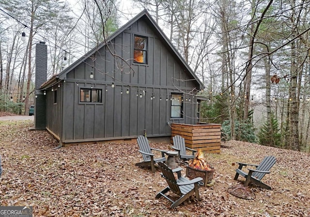 back of property with a fire pit