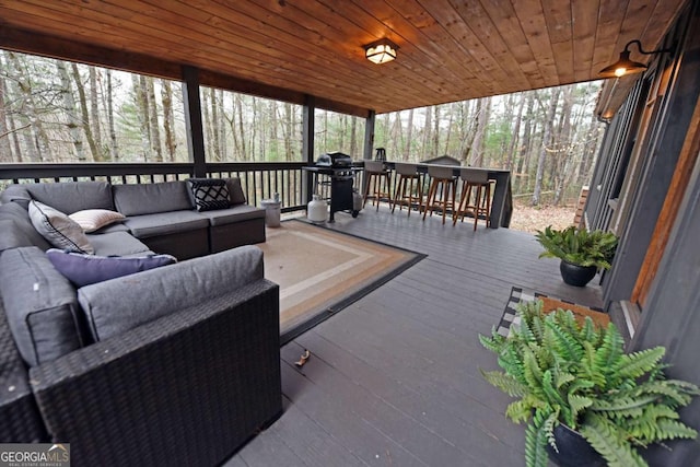 wooden deck featuring outdoor lounge area and grilling area