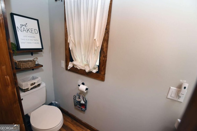 bathroom with hardwood / wood-style floors and toilet