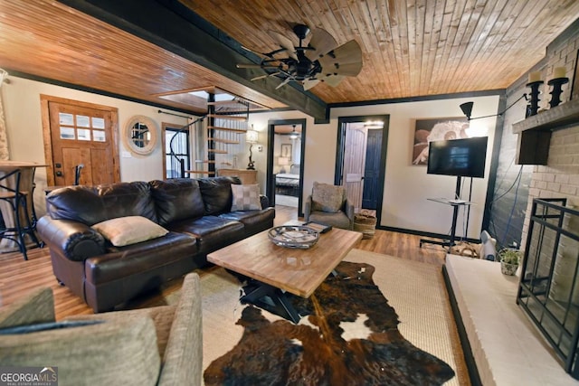 living room with ceiling fan, ornamental molding, wooden ceiling, and light hardwood / wood-style floors