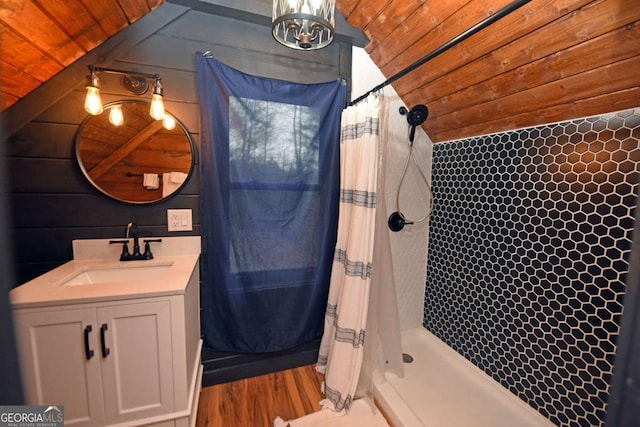 bathroom with vanity, lofted ceiling, wood walls, and wood ceiling