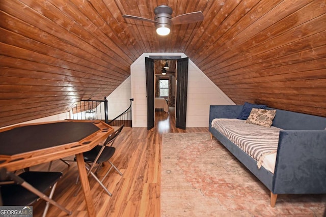 office featuring hardwood / wood-style floors, lofted ceiling, wooden ceiling, wooden walls, and ceiling fan