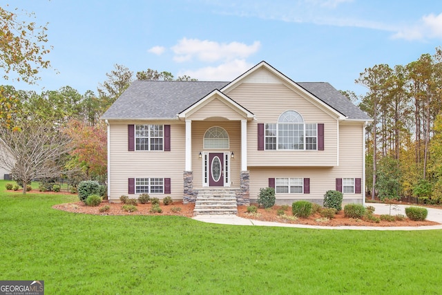 raised ranch with a front yard