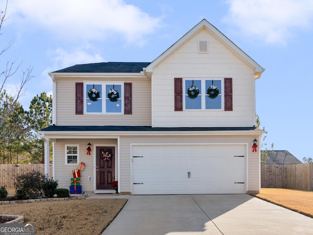 view of property featuring a garage and a front lawn