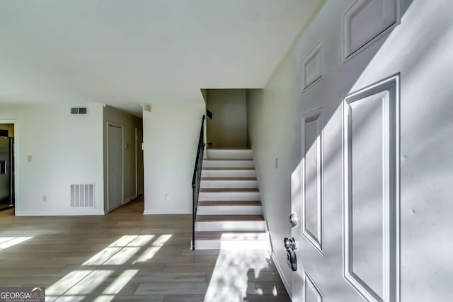 stairway with hardwood / wood-style flooring