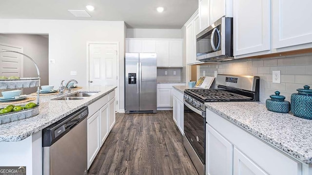 kitchen with white cabinets, appliances with stainless steel finishes, backsplash, and sink