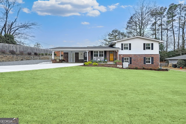 tri-level home featuring a front yard, a porch, and a carport